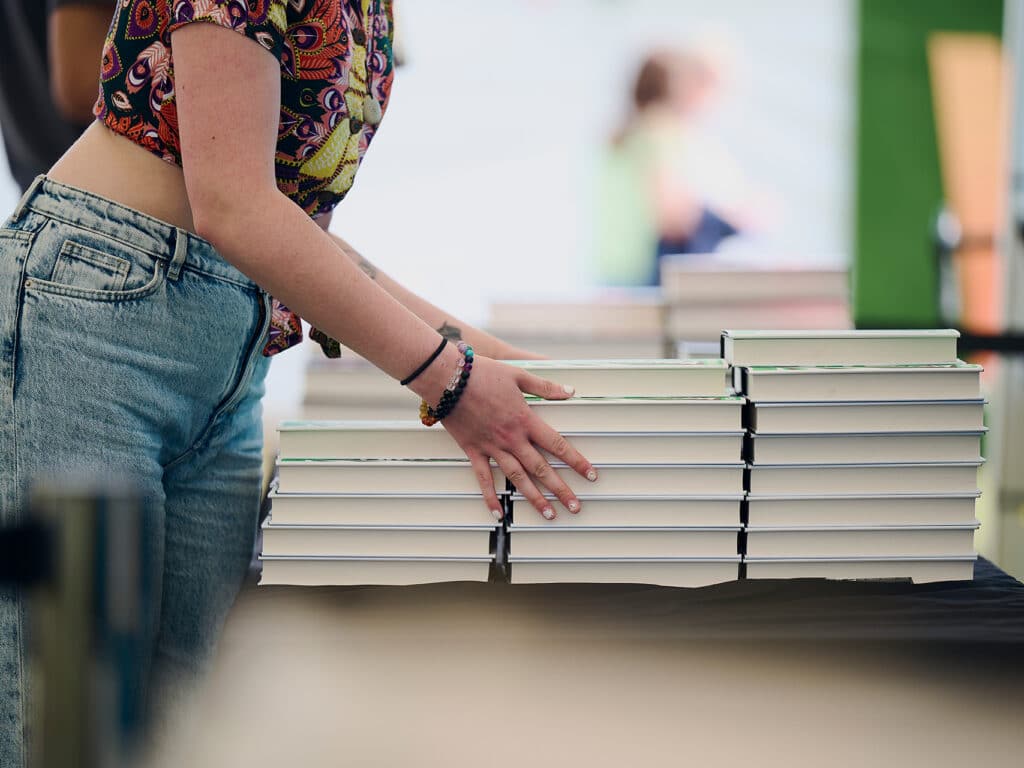 A Person Stacking books