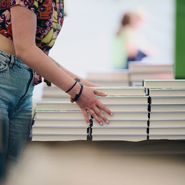 A Person Stacking books