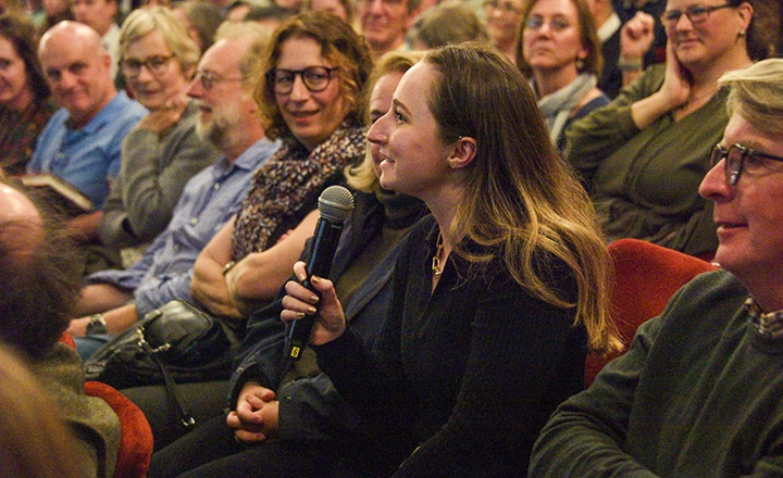 An audience member asking a question into the microphone