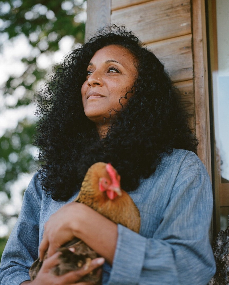 Headshot of Claire Ratinon holding a chicken