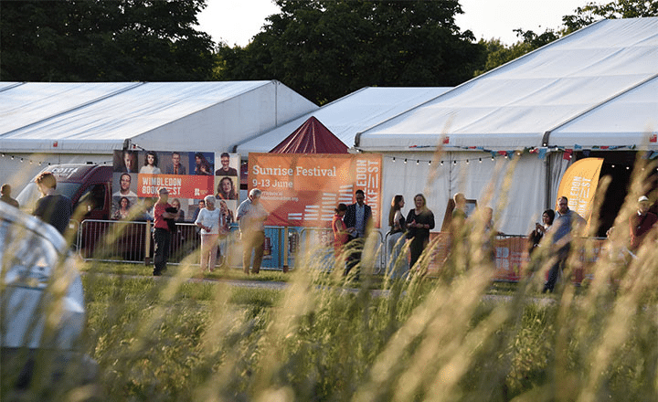 Bookfest Banners behind a queue of people getting into event tents