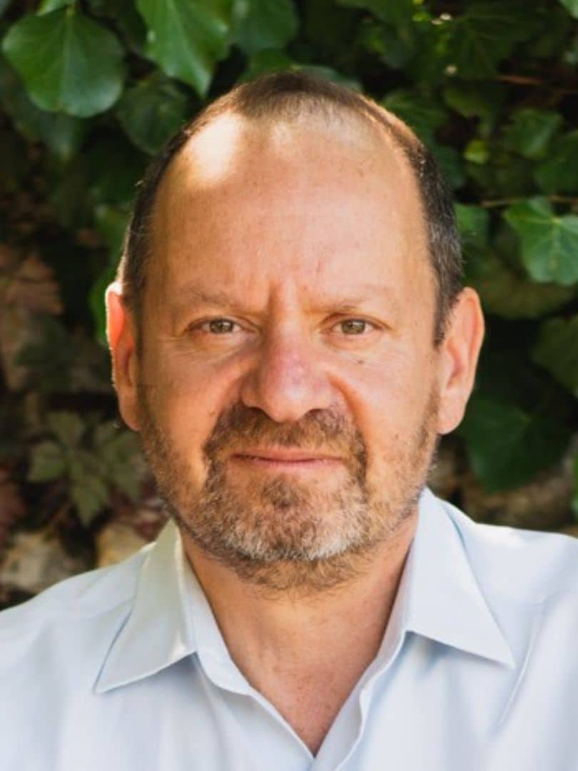 Philippe Sands, author and human rights lawyer, holding The Book of Sands at a speaking event.